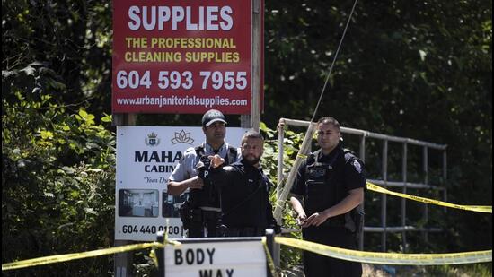 Surrey Police officers and an RCMP officer work at the scene of a shooting in Surrey, British Columbia, Canada, on Thursday. (AP)