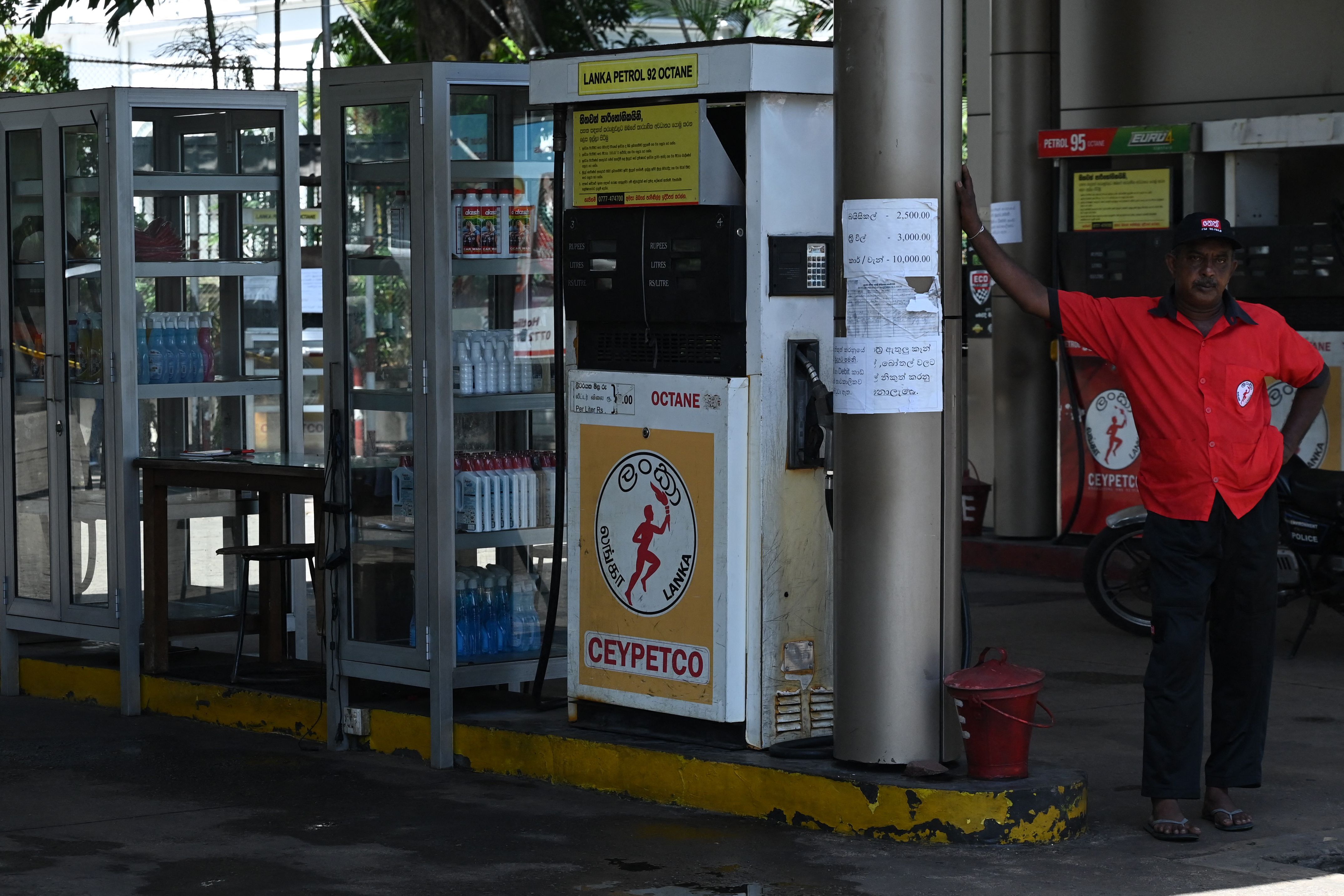 A worker stands at an empty fuel station in Colombo on Thursday. (AFP Photo) A worker stands at an empty fuel station in Colombo on Thursday. (AFP Photo)