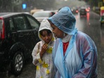 A woman with her ward amid monsoon rains in New Delhi on Saturday. (PTI) A woman with her ward amid monsoon rains in New Delhi on Saturday. (PTI)