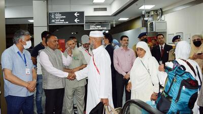 Kashmir divisional commissioner Pandurang K Pole and senior police officials receive the first batch of 145 Kashmiri Muslim pilgrims returning from Mecca, at Srinagar on Saturday. (ANI)