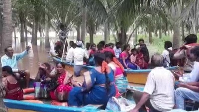 Couple reach wedding destination in boats in flood-hit Andhra Pradesh. (ANI) Couple reach wedding destination in boats in flood-hit Andhra Pradesh. (ANI)