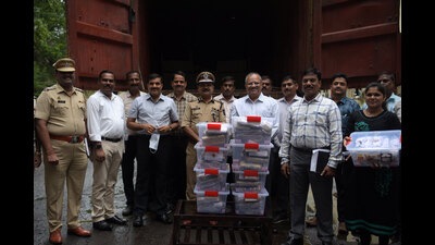 BK Singh (6th from left), Navi Mumbai Commissioner of Police, and other police officials with the heroin and the container that were seized in Panvel. Police said that the container was booked by a person in Delhi. (BACHCHAN KUMAR/HT PHOTO)