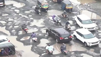 Vapi-Silvassa National Highway 48 remains completely riddled with potholes after heavy rain. (ANI)