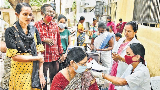 A medic administers a booster shot of Covid vaccine to a woman in Hyderabad on Friday. (PTI) A medic administers a booster shot of Covid vaccine to a woman in Hyderabad on Friday. (PTI)