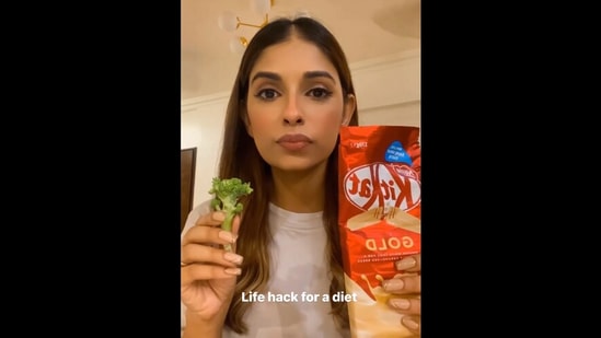 The image, taken from the viral video, shows actor Avantika Hundal holding broccoli and chocolate for hilarious diet ‘hack’. (Instagram/@avantikahundaal)