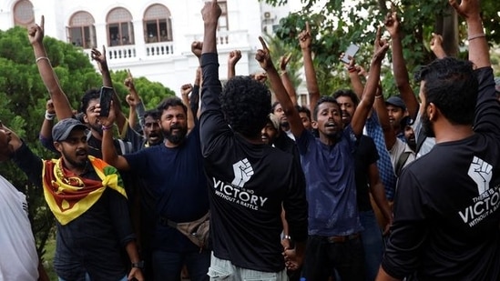 Protesters shout slogans as they vacate the Sri Lankan Prime Minister Ranil Wickremesinghe's office, amid the country's economic crisis, in Colombo.&nbsp;