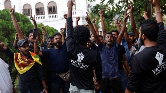 Protesters shout slogans as they vacate the Sri Lankan Prime Minister Ranil Wickremesinghe's office, amid the country's economic crisis, in Colombo. 