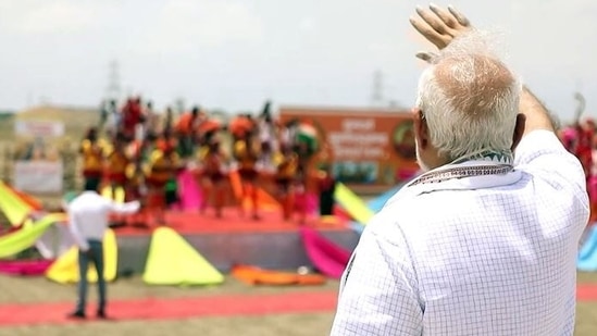 Prime Minister Narendra Modi waves to the people at the site of the inauguration of the Bundelkhand Expressway, at Kaitheri Village(ANI Photo)