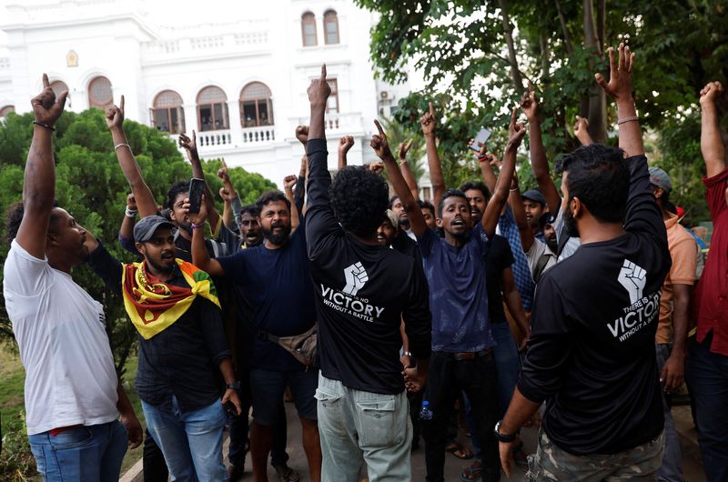 Protesters shout slogans as they vacate the Sri Lankan Prime Minister Ranil Wickremesinghe's office, amid the country's economic crisis, in Colombo.&nbsp; (Reuters)