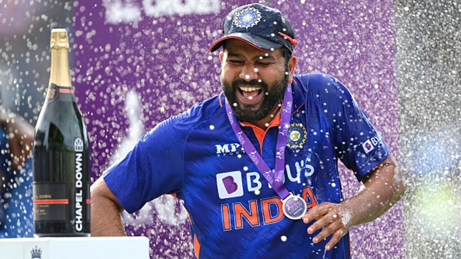watch-kohli-s-priceless-reaction-to-pant-dhawan-showering-rohit-sharma-with-champagne-after-india-s-series-win
