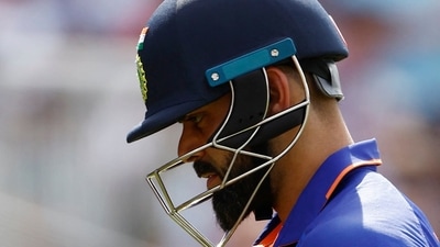 Virat Kohli walks after being caught by Jos Buttler off the bowling of Reece Topley (Reuters)