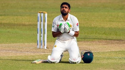 Babar Azam celebrates after scoring a century on Day 2 of the first Test between Sri Lanka and Pakistan (AFP)