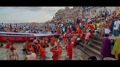 Kanwariyas take a holy dip in the Ganga in Varanasi on Sunday. (HT)