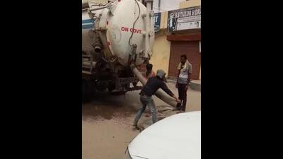 Workers of the Ludhiana MC’s contractor dumping untreated sewage in the sewerage line through a manhole, metres away from the Buddha Nullah. (HT Photo) Workers of the Ludhiana MC’s contractor dumping untreated sewage in the sewerage line through a manhole, metres away from the Buddha Nullah. (HT Photo)