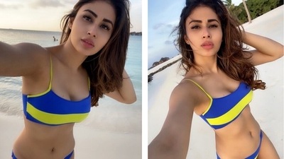 Mouni captioned her post, "Mentally here." The Brahmastra actor wore a bright yellow and blue-coloured bikini set for the beach photoshoot. The bikini top comes with spaghetti straps, a plunging neckline and cropped midriff-baring hem length. (Instagram) Mouni captioned her post, "Mentally here." The Brahmastra actor wore a bright yellow and blue-coloured bikini set for the beach photoshoot. The bikini top comes with spaghetti straps, a plunging neckline and cropped midriff-baring hem length. (Instagram)