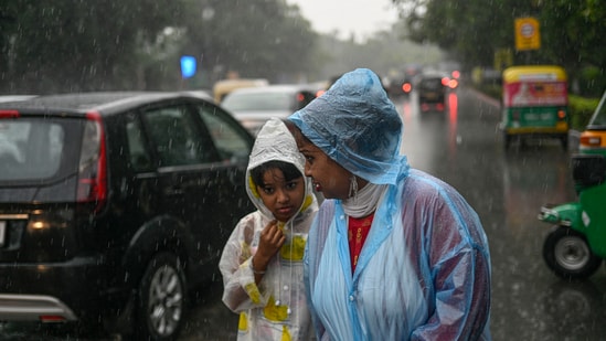 A woman with her ward amid monsoon rains in New Delhi&nbsp;