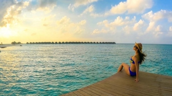 Mouni's bikini set is a perfect pick for a beach vacation. You can don it like Mouni, creating a fuss-free look, or glam it up by adding a layer of printed cover-up, boho-chic jewellery and a top knot.(Instagram)