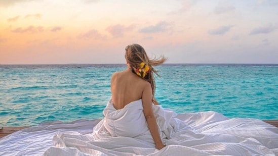 Earlier, Mouni had posted pictures of herself lounging by the sea on a wooden deck, wrapped in a white blanket, and showing off her bare back. The star captioned her post, "My corner of the sky." It showed Mouni marvelling at the gorgeous sunset.(Instagram)