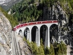 A train passes the Landwasser Viaduct in Grisons, Switzerland A train passes the Landwasser Viaduct in Grisons, Switzerland