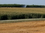 Automatic sprinklers connected to a dewatering pump irrigate dried corn fields near Piacenza, northern Italy. Automatic sprinklers connected to a dewatering pump irrigate dried corn fields near Piacenza, northern Italy.