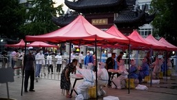 People line up to get tested for the coronavirus disease (COVID-19) at a nucleic acid testing site, in Shanghai China.