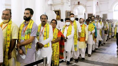 On Monday, when all the BJP MLAs reached the West Bengal Legislative Assembly in a bus, they could be seen wearing tribal uttariyas around their necks. While some also wore it like a turban, a few others wore tribal outfits. (ANI PHOTO.) On Monday, when all the BJP MLAs reached the West Bengal Legislative Assembly in a bus, they could be seen wearing tribal uttariyas around their necks. While some also wore it like a turban, a few others wore tribal outfits. (ANI PHOTO.)