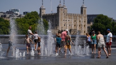 People cool off in the water fountains by the Scoop during a heatwave, in London. (REUTERS)