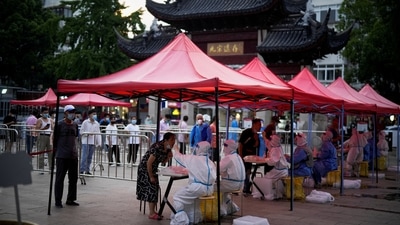 People line up to get tested for the coronavirus disease (COVID-19) at a nucleic acid testing site, in Shanghai China. (REUTERS)