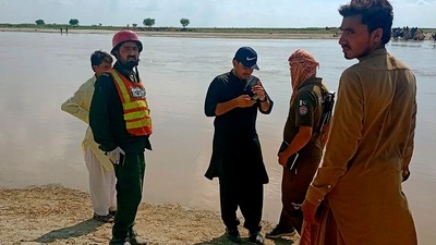 Officials coordinate an operation to recover bodies from the Indus River after a boating accident, in Sadiqabad district in Pakistan. (AP)