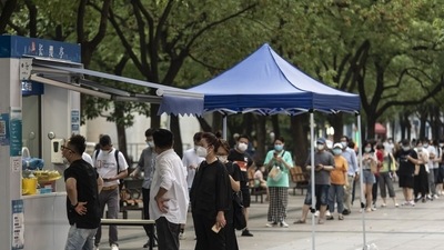 Office workers line up at a Covid testing booth in downtown Shanghai. (Bloomberg) Office workers line up at a Covid testing booth in downtown Shanghai. (Bloomberg)