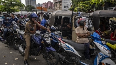 Sri Lankans wait in queue to buy petrol at a fuel station, in Colombo, Sri Lanka, July 17, 2022. (AP Photo/Rafiq Maqbool) (AP)