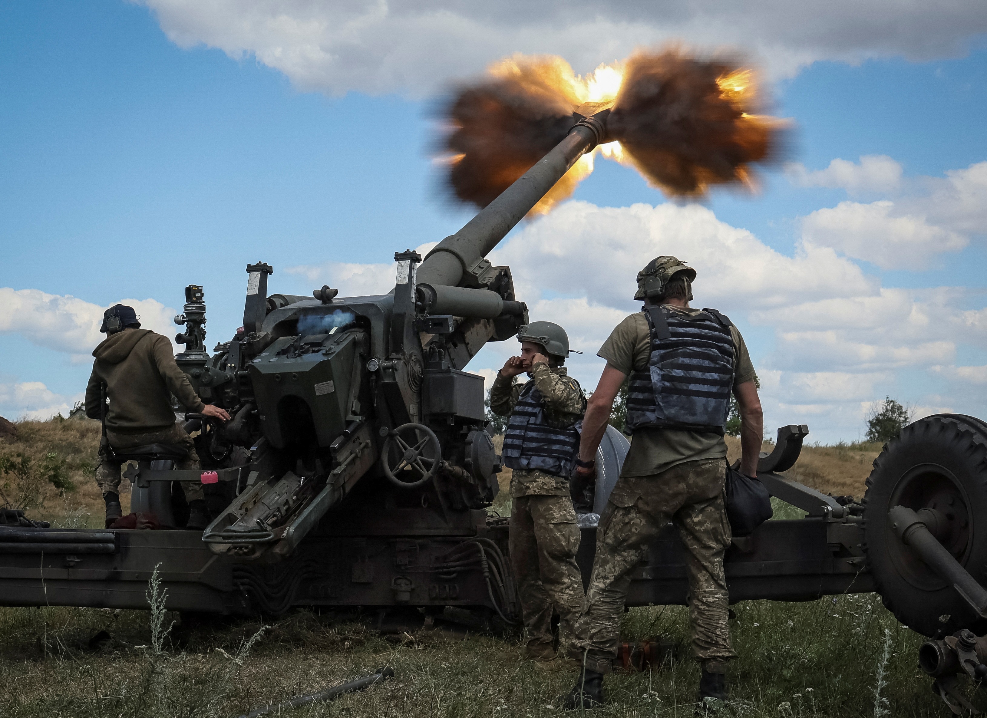 Ukrainian service members fire a shell from a towed howitzer FH-70 at a front line, as Russia's attack on Ukraine continues, in Donbas Region on Monday.&nbsp; (REUTERS)