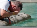 A man refreshes his face at a fountain in Trafalgar Square in central London, Tuesday.(AP) A man refreshes his face at a fountain in Trafalgar Square in central London, Tuesday.(AP)