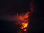 In Spain, a wildfire raced across a field and engulfed a excavator near the northern town of Tabara, forcing the driver to run for his life as flames burned the clothes off his back. The heatwave has lasted more than a week and caused more than 510 heat-related deaths, according to estimates from the Carlos III Health Institute. The photo shows a view of a windmill burning by a wildfire at night outside Tabara, Zamora, in Spain. (REUTERS)