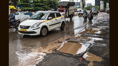 Vehicles on a pothole-ridden road at Gunjan chowk, Yerawada on Tuesday. (Shankar Narayan/HT PHOTO) Vehicles on a pothole-ridden road at Gunjan chowk, Yerawada on Tuesday. (Shankar Narayan/HT PHOTO)