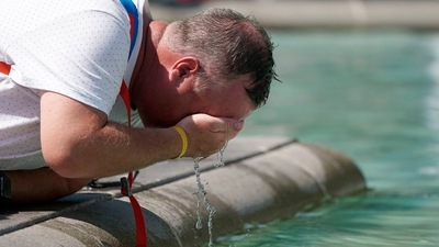 A man refreshes his face at a fountain in Trafalgar Square in central London, Tuesday. (AP) A man refreshes his face at a fountain in Trafalgar Square in central London, Tuesday. (AP)