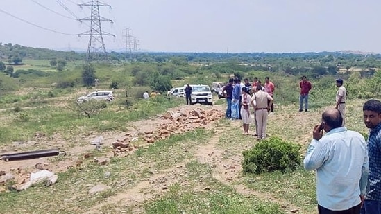 Police personnel at the crime scene after DSP Surender Singh Bishnoi was allegedly mowed down to death by the mining mafia at Pachgaon in Nuh district.(PTI photo)