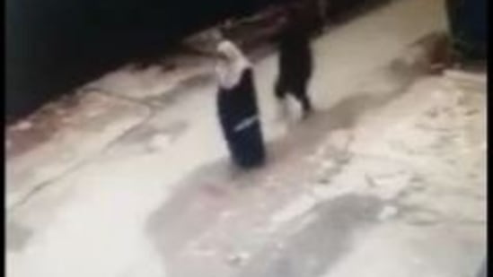 The CCTV grab of the burqa-clad woman before she was groped.(Twitter/Zobia Raja)