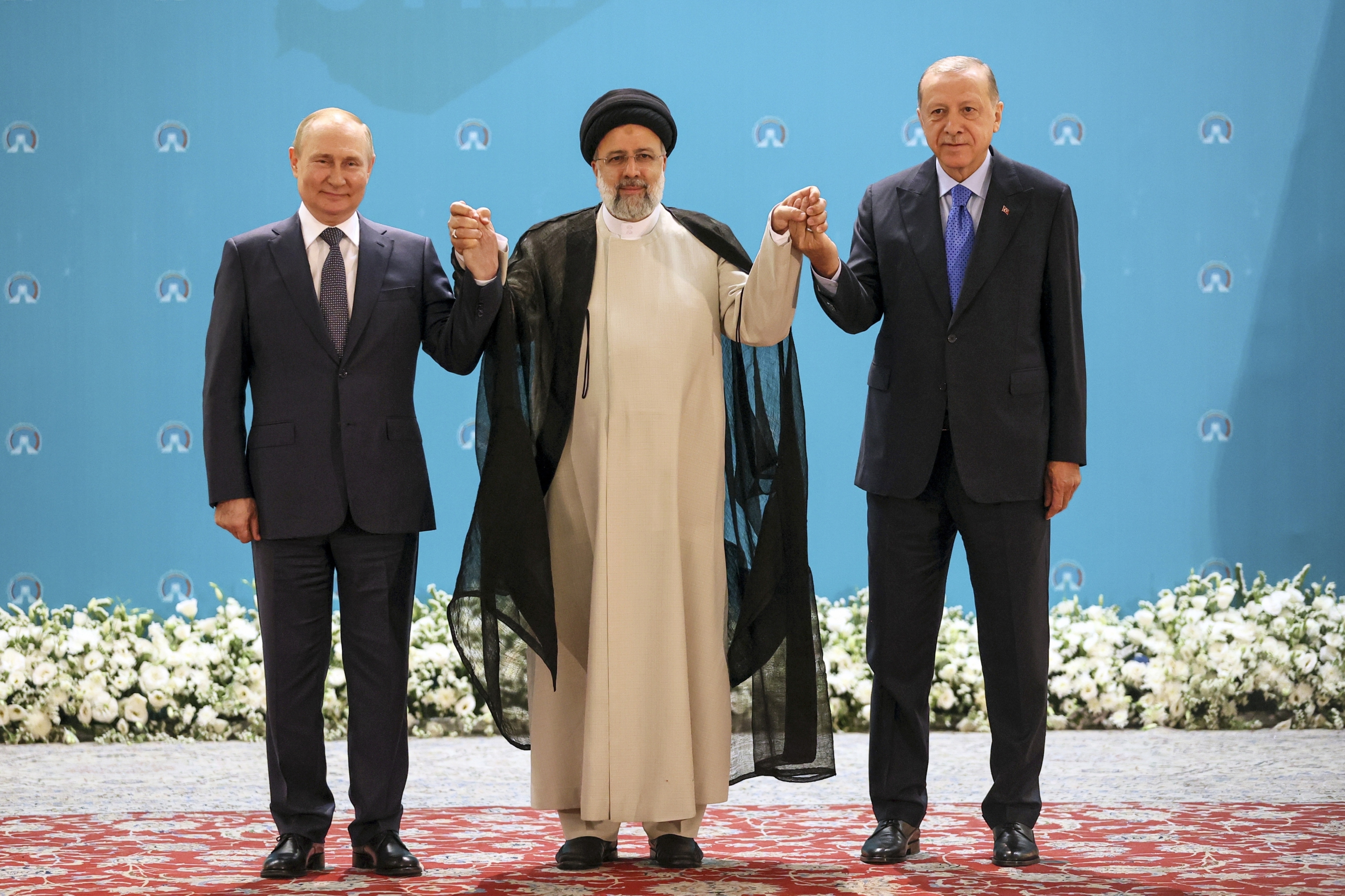 Russian President Vladimir Putin, left, Iranian President Ebrahim Raisi, center, and Turkish President Recep Tayyip Erdogan pose for a photo prior to their talks at the Saadabad palace, in Tehran. (AP) Russian President Vladimir Putin, left, Iranian President Ebrahim Raisi, center, and Turkish President Recep Tayyip Erdogan pose for a photo prior to their talks at the Saadabad palace, in Tehran. (AP)