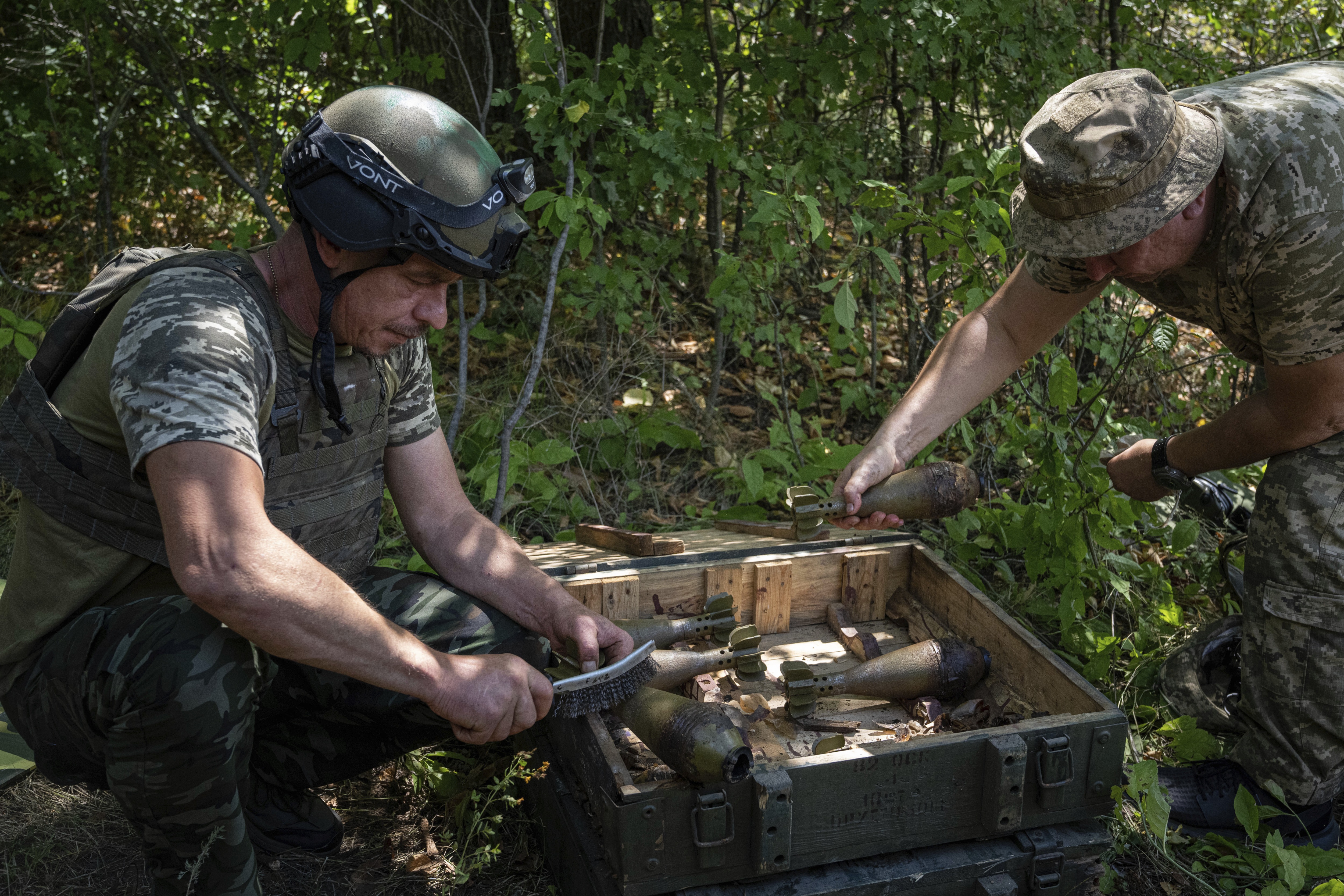 Ukrainian servicemen clean mortar shells during training in Kharkiv region, on Tuesday. (AP) Ukrainian servicemen clean mortar shells during training in Kharkiv region, on Tuesday. (AP)