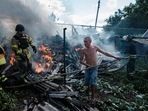 A local resident helps firefighters to put out a fire in a yard of a house in the town of Bakhmut following an airstrike.(AFP) A local resident helps firefighters to put out a fire in a yard of a house in the town of Bakhmut following an airstrike.(AFP)