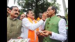 Madhya Pradesh chief minister Shivraj Singh Chouhan being offered sweets by state BJP president VD Sharma as they celebrate the party's victory in the second phase of local bodies elections, at BJP headquarters in Bhopal on Wednesday. (PTI)