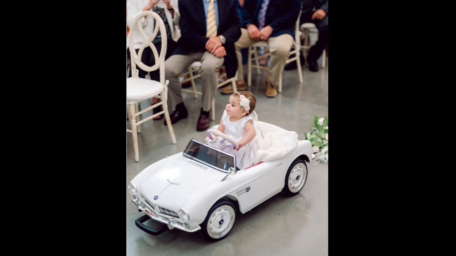 Little girl makes spectacular entrance as a flower girl. Watch ...