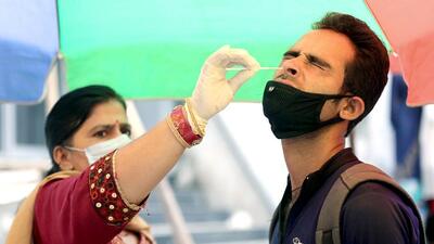 A healthcare worker collects a nasal swab sample of a man for Covid-19 testing, amid a recent surge in the coronavirus cases in India, in Jammu on Sunday. (ANI)