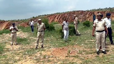 Police personnel inspect the incident site where Tawadu (Mewat) DSP Surendra Singh, died after being allegedly run over by a dumper driver, in Nuh. (ANI)