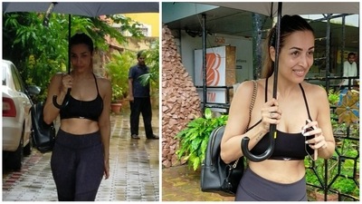 Malaika Arora continues to stick to her fitness regime no matter what. The yoga enthusiast was spotted at her yoga studio on Wednesday amid heavy rain. She smiled at the paparazzi as she walked towards her car with an umbrella in hand. (Varinder Chawla) 