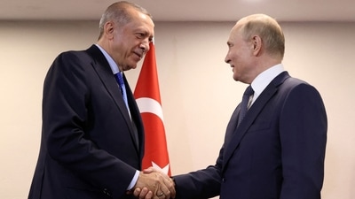 Turkish President Recep Tayyip Erdogan (L) shaking hand with Russian President Vladimir Putin during a meeting as part of the Astana Trilateral Summit at the Tehran International Conference Hall in Tehran. (AFP)