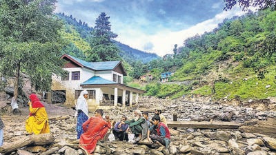 Locals taking refuge from flash floods triggered by heavy rain, in Kahara area of Doda district. (PTI)