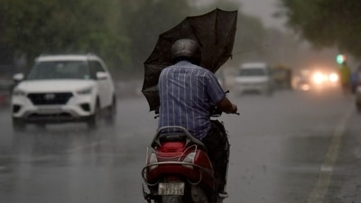 Commuters travel during heavy rain, in Noida, India, on Wednesday, July 20, 2022. (Photo by Sunil Ghosh/Hindustan Times) 