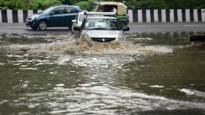 Commuters pass through a heavily waterlogged stretch of road, in Noida, India, on Wednesday, July 20, 2022. (Photo by Sunil Ghosh/Hindustan Times) 
